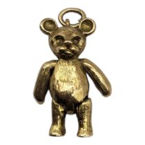 A VINTAGE 9CT GOLD TEDDY BEAR PENDANT Articulated body and hanging bale. (approx 3cm x 2cm)