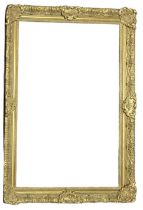 AN EARLY 20TH CENTURY GILDED RECTANGULAR PICTURE FRAME With carved scrolled decoration. (aperture