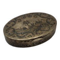 A 19TH CENTURY RUSSIAN SILVER AND NIELLO ENAMEL OVAL SNUFF BOX With Neillo landscape to lid and gilt