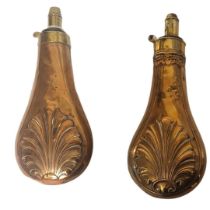 TWO 19TH CENTURY COPPER AND BRASS POWDER FLASKS Having embossed shell form decoration. (approx 20cm)