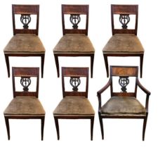 A SET OF SIX FRENCH EMPIRE PERIOD MAHOGANY DINING CHAIRS Including one carver with pierced lyre