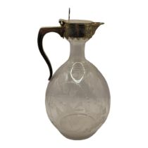 A VICTORIAN SILVER AND ETCHED GLASS CLARET JUG Having a single handle with engraved decoration,