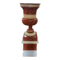 A LARGE FAUX ROUGE MARBLE CAMPAGNA URN ON PLINTH. (56cm x 56cm x 155cm) Condition: good throughout