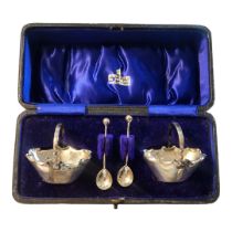 A PAIR OF VICTORIAN BASKET SILVER SALTS With spoons, in a fitted velvet lined box marked 'Arthur