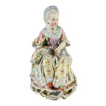 MEISSEN, AN 18TH CENTURY GERMAN PORCELAIN FIGURE, TITLED ‘GIRL WITH YARN’, MODELLED BY MICHEL VICTOR