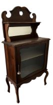 A VICTORIAN MAHOGANY MIRRORED BACK MUSIC CABINET With single glazed door, raised on cabriole legs.