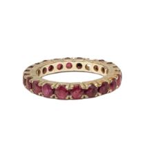 A VINTAGE 14CT WHITE GOLD AND RUBY ETERNITY RING The round cut rubies (approx. 3mm each) set in claw