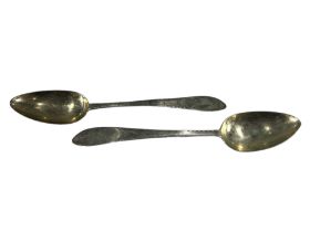 A PAIR OF LATE 19TH CENTURY AMERICAN SILVER SERVING SPOONS Having decorative chased terminals,