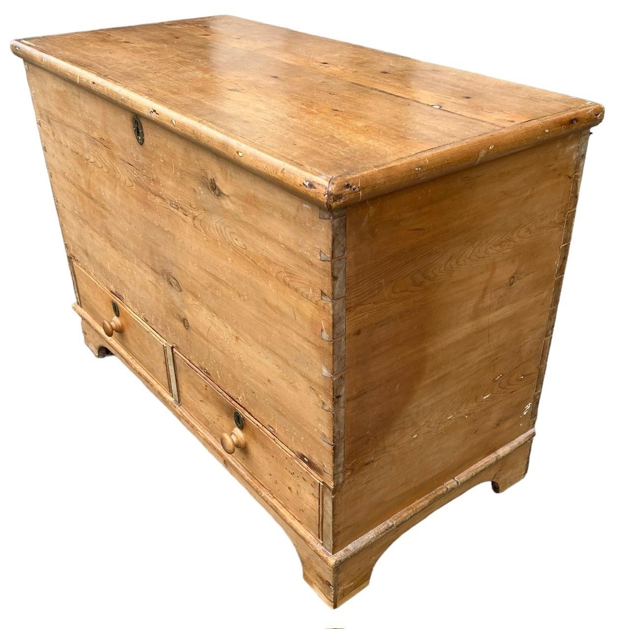 A 19TH CENTURY STRIP AND WAXED PINE MULE CHESTWith hinged lid above two drawers, raised on bracket - Image 2 of 3