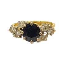 AN 18CT YELLOW AND WHITE GOLD, SAPPHIRE AND DIAMOND RING The central round cut sapphire (approx