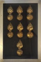 A COLLECTION OF SEVEN BRASS FUSILIER HEADDRESS BADGES To include Inniskillin and Lancashire