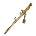 A GERMAN WWII NAVAL OFFICER’S DAGGER AND DECORATED SCABBARD With yellow grip, silver braid knot,