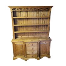 A VICTORIAN DESIGN PINE FARMHOUSE BREAKFRONT DRESSER With carved and pierced gallery open shelves