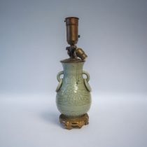 A 19TH CENTURY STYLE BRASS AND CERAMIC CHINESE CELADON LAMP With three light fixtures above an urn