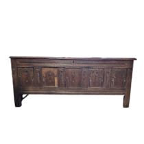 A LARGE JAMES II PERIOD OAK COFFER With five panelled front, on stile legs. (w 180cm x d 67cm x h