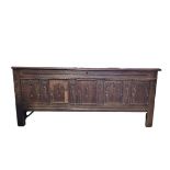 A LARGE JAMES II PERIOD OAK COFFER With five panelled front, on stile legs. (w 180cm x d 67cm x h