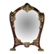 A LARGE ART NOUVEAU MAHOGANY AND BRASS EASEL MIRROR Having brass female mask finial and floral