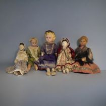 TWO EARLY 20TH CENTURY DUTCH WOODEN DOLLS Naive painted faces, provincial dress, Continental wax