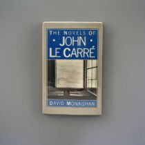 DAVID MONAGHAN, THE NOVELS OF JOHN LE CARRÉ, SIGNED, 1985 Dust jacket worn to edges.