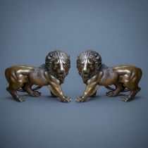 A PAIR OF JAPANESE STYLE BRONZE LIONS In the manner of the Meiji period, facing opposing directions.