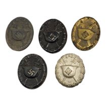 A COLLECTION OF FIVE WWII GERMAN WOUND BADGES Three stamped steel to include two black badges and