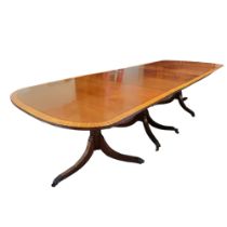 A MID 20TH CENTURY SHERATON REVIVAL MAHOGANY AND SATINWOOD BANDED TRIPLE PILLAR DINING TABLE With