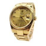 ROLEX, DAYDATE, AN 18CT GOLD AND DIAMOND GENT’S WRISTWATCH Gold tone dial with diamond number