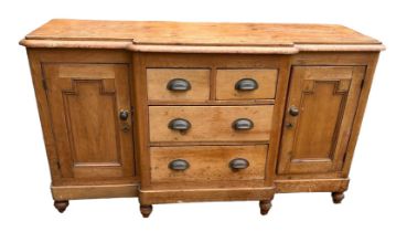 A VICTORIAN PINE BREAKFRONT DRESSER The central drawers flanked by cupboards. (150cm x 54cm x