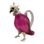 A VICTORIAN STYLE SILVER PLATED PARROT OIL DECANTER The hinged head on a cranberry glass body,