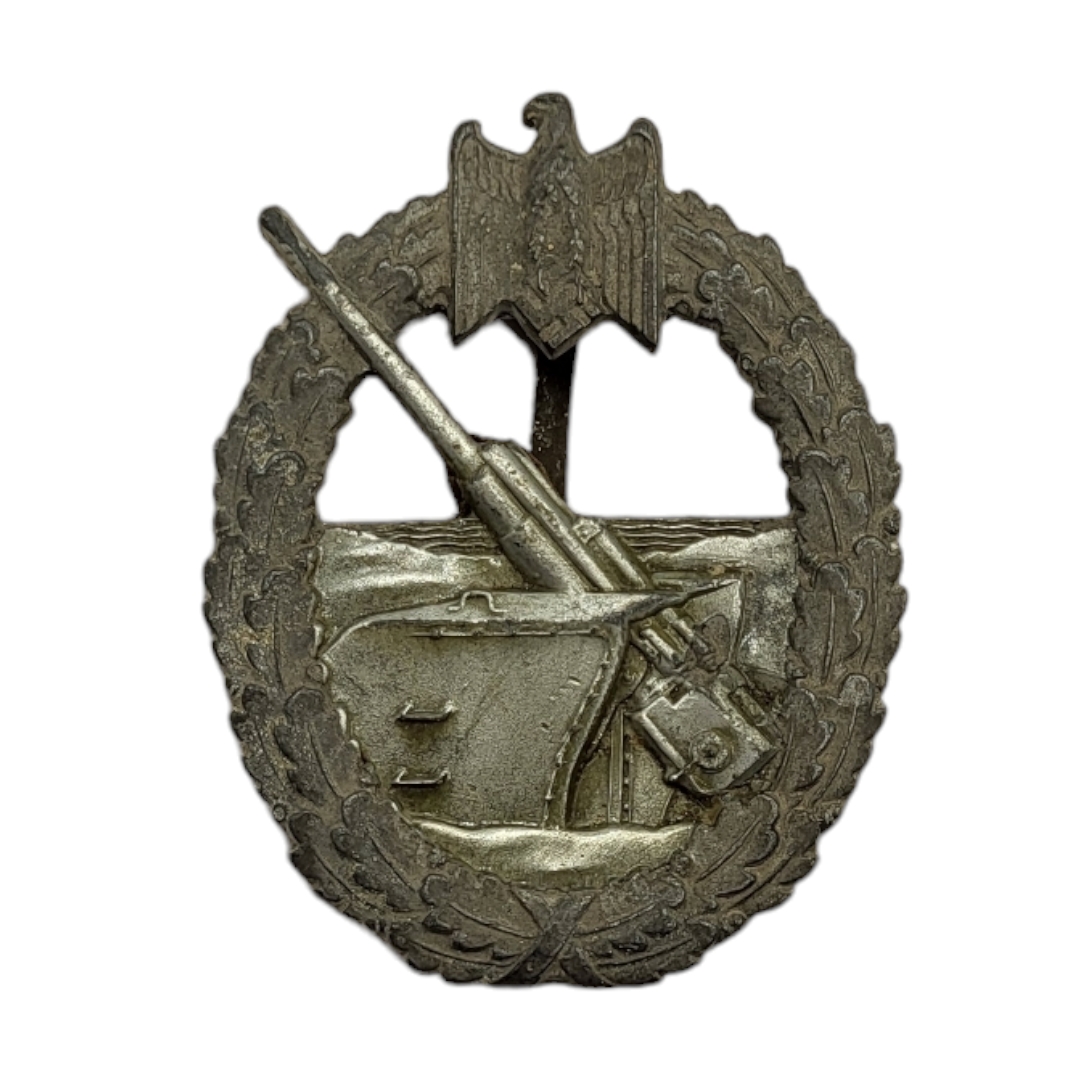 A WWII GERMAN KRIEGSMARINE COASTAL ARTILLERY BADGE Eagle mount with navel gun within a wreath. (