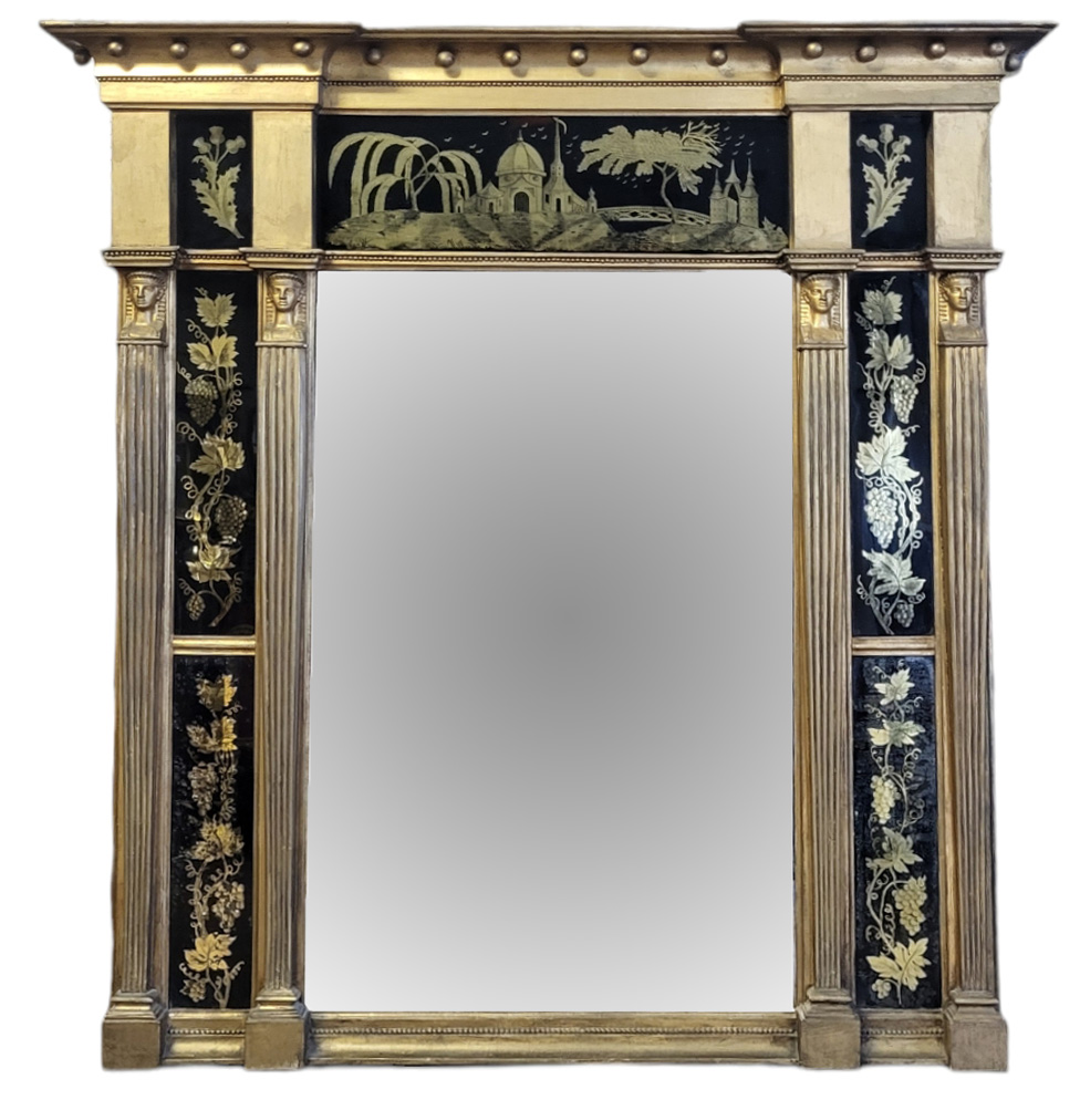 A 19TH CENTURY EGYPTIAN REVIVAL GILT FRAMED MIRROR The break front cornice above reverse glass