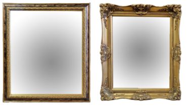 A LATE 20TH CENTURY GILDED WALL MIRROR The bevelled glass with parcel gilt scroll moulded frame,