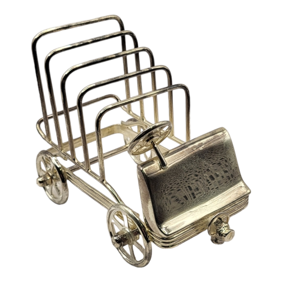 A SILVER PLATED GOLF CART TOAST RACK With working wheel mechanism. (10cm x 16cm x 12cm) Condition: