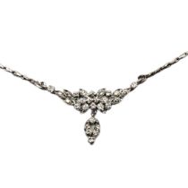 A VINTAGE WHITE METAL AND DIAMOND NECKLACE Having an arrangement of round cut stones forming a