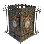 A VICTORIAN AESTHETIC MOVEMENT STAINED GLASS AND METAL LANTERN Four coloured glass panels within a