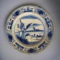 AN 18TH CENTURY ENGLISH DELFTWARE BLUE AND WHITE TIN GLAZED EARTHENWARE CHARGER The centre painted