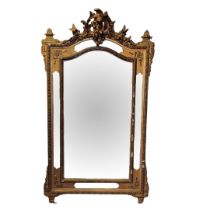 A VICTORIAN GILT FRAMED MIRROR Crested with putti and birds above sectional silvered plates. (88cm x