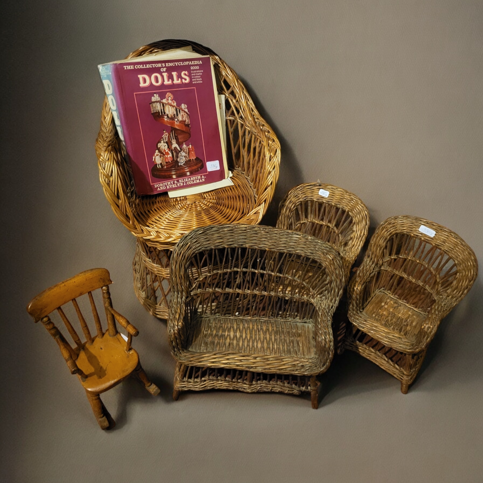 A MIXED COLLECTION OF CHILD'S DOLLS, FURNITURE AND TEDDY BEARS Consisting of a pair of wicker