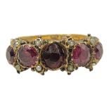 A 19TH CENTURY YELLOW METAL, GARNET AND SEED PEARL RING Having an arrangement of graduated stones