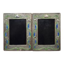 A PAIR OF ART NOUVEAU STYLE SILVER AND ENAMEL PHOTOGRAPH FRAMES Embossed floral design and wooden