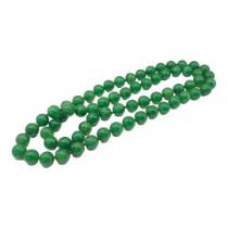 A STRING OF ORIENTAL STYLE JADEITE BEADS. (43cm) Condition: good overall