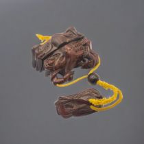 A JAPANESE WOODEN CRAB INRO The two halves held shut by ojime on cords with a stylised octopus