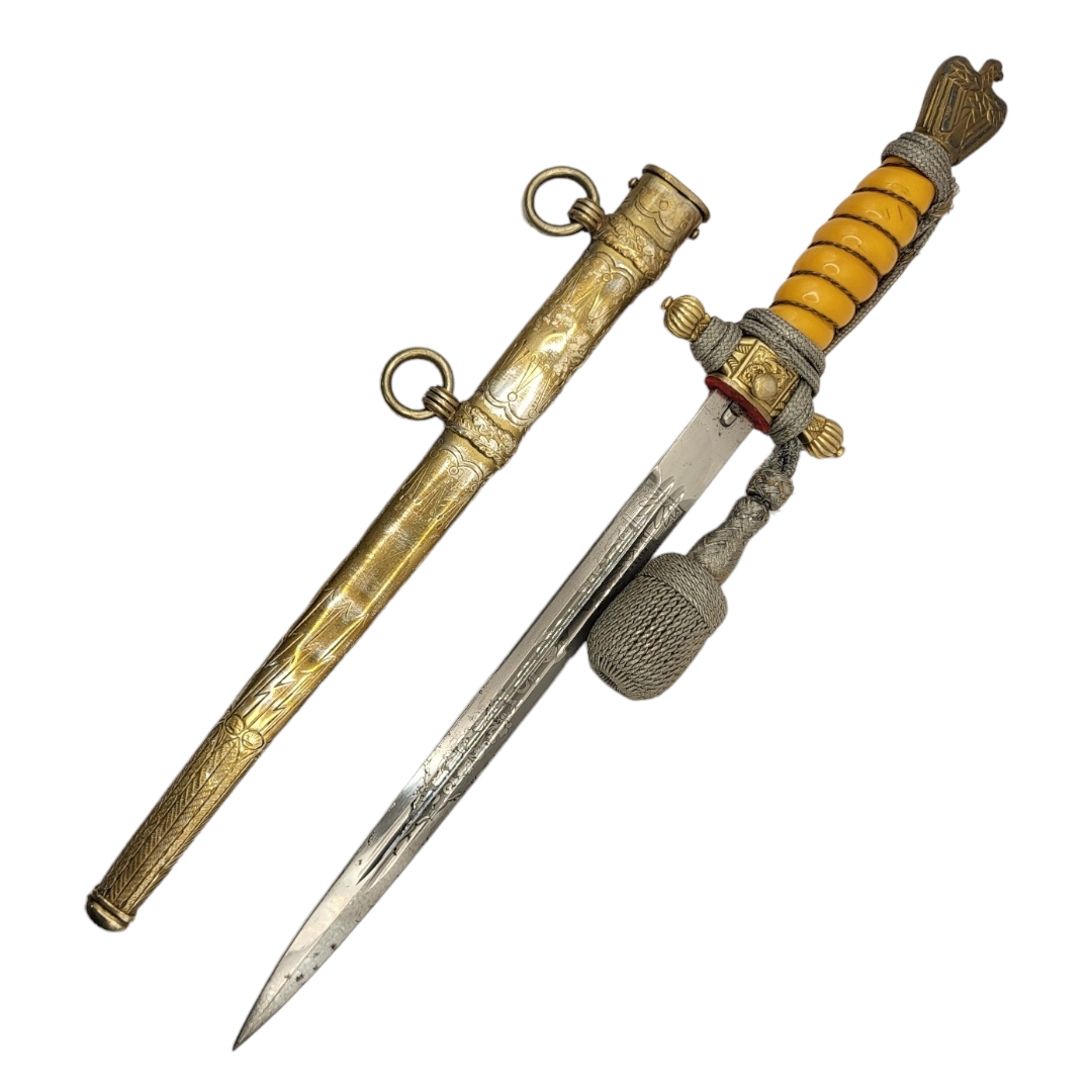 A GERMAN WWII NAVAL OFFICER’S DAGGER AND DECORATED SCABBARD With yellow grip, silver braid knot, - Image 2 of 4