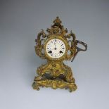 DELETTREZ, A FRENCH 19TH CENTURY GILT BRASS MANTLE CLOCK Rococo form with scrolled case and white