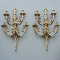 A PAIR OF LARGE CONTINENTAL GILT BRONZE WALL SCONCES With pierced foliage backs supporting single