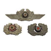 A GERMAN WWII LUFTWAFFE NCO VISOR CAP COCKADE Stamped metal construction, together with two army