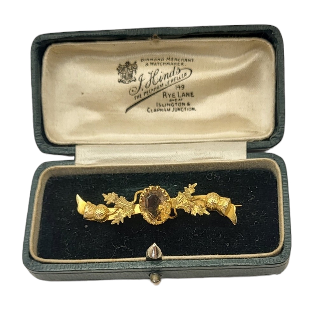 HINDS OF ISLINGTON, A VICTORIAN 9CT GOLD AND CITRINE BROOCH The oval cut stone with Scottish thistle
