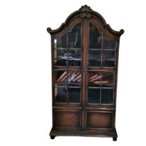 AN EARLY 20TH CENTURY DUTCH OAK DISPLAY CABINET The carved domed top above two partial glazed