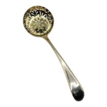 A GEORGIAN SILVER SAUCE LADLE Having a beaded edge and pierced gilt bowl, hallmarked John Lambe,