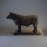 A BRONZE STATUE OF A BULL On a black marble pedestal base. (9cm x 21cm x 18cm) Condition: good